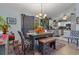 Stylish dining area adjacent to kitchen, featuring elegant decor, hardwood floors, and modern lighting at 6367 Facet Ln, Port Charlotte, FL 33981