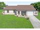 Charming single-story home with a well-maintained lawn, screen porch and attached garage at 6367 Facet Ln, Port Charlotte, FL 33981
