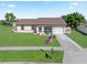 Charming home exterior with well-maintained lawn, landscaped garden, and inviting curb appeal at 6367 Facet Ln, Port Charlotte, FL 33981