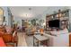 Open concept living room featuring stylish decor, hardwood floors, and a large shelving unit at 6367 Facet Ln, Port Charlotte, FL 33981