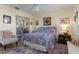 Comfortable main bedroom features carpet flooring, a ceiling fan, and decorative wall art at 6367 Facet Ln, Port Charlotte, FL 33981