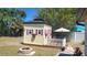 A cute playhouse sits outside on a well manicured lawn surrounded by plenty of shade at 6367 Facet Ln, Port Charlotte, FL 33981
