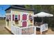 Backyard shed with cheerful colors, a covered deck, and a seating area for enjoying the outdoors at 6367 Facet Ln, Port Charlotte, FL 33981