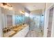 Modern bathroom with dual sinks, granite counters, stylish fixtures, and a glass enclosed walk-in shower at 721 Redbud Ct, Englewood, FL 34223