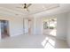 This main bedroom has tile floors, a ceiling fan, a glass shower, and sliding glass doors to the lanai at 721 Redbud Ct, Englewood, FL 34223