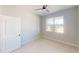 Well-lit bedroom with a window for natural light and a stylish paneled interior door at 721 Redbud Ct, Englewood, FL 34223