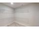 This walk-in closet has tiled floors and wire shelving for optimal storage space at 721 Redbud Ct, Englewood, FL 34223