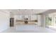 Modern kitchen boasts a large island, stainless steel appliances, and ample cabinet space at 721 Redbud Ct, Englewood, FL 34223