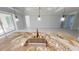 Close-up of a kitchen island with granite countertops, a stainless steel sink, and pendant lighting at 721 Redbud Ct, Englewood, FL 34223