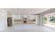 Spacious kitchen with stainless steel appliances, ample counter space, and a large island with a sink at 721 Redbud Ct, Englewood, FL 34223