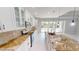 Bright kitchen with granite countertops, white cabinets, stainless steel appliances, and sliding glass doors at 721 Redbud Ct, Englewood, FL 34223