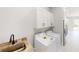 Convenient laundry room includes new washer/dryer set and adjacent utility sink at 721 Redbud Ct, Englewood, FL 34223