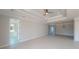 Open living room with tray ceiling, recessed lighting, and tile flooring at 721 Redbud Ct, Englewood, FL 34223