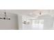 Open-concept living room with large windows, a decorative chandelier, and seamless access to the kitchen at 721 Redbud Ct, Englewood, FL 34223