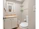 Bathroom features a vanity with a marble countertop, a large mirror, and two glass shelves at 8 Quails Run Blvd # 10, Englewood, FL 34223