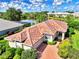 Aerial view of house with tile roof and landscaping at 3413 Pennyroyal Rd, Port Charlotte, FL 33953