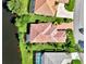 Bird's-eye view of a luxurious home with a distinctive tile roof and a canal-side location at 3413 Pennyroyal Rd, Port Charlotte, FL 33953
