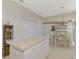 Kitchen with island, white cabinets, and pantry at 3413 Pennyroyal Rd, Port Charlotte, FL 33953