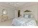 Bright bedroom with floral bedding and en-suite bathroom at 3413 Pennyroyal Rd, Port Charlotte, FL 33953