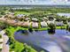 Aerial view of home and community by the lake at 3413 Pennyroyal Rd, Port Charlotte, FL 33953