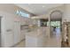 Kitchen with island, white cabinets and breakfast nook at 3413 Pennyroyal Rd, Port Charlotte, FL 33953