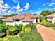 One-story house with brick driveway and landscaped yard at 3413 Pennyroyal Rd, Port Charlotte, FL 33953