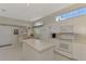 Spacious kitchen with white cabinets, island, and appliances at 3413 Pennyroyal Rd, Port Charlotte, FL 33953