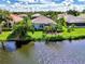 Aerial view of home on the water with a large backyard and lush landscaping at 3413 Pennyroyal Rd, Port Charlotte, FL 33953
