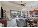 Bright living room with open floor plan, comfy seating, and view of the pool at 15608 Lakeland Cir, Port Charlotte, FL 33981