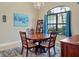 Charming dining area with a wood table, four chairs and decorative artwork at 15608 Lakeland Cir, Port Charlotte, FL 33981