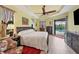 Spacious bedroom with pool access, featuring a king-size bed and ample natural light at 15608 Lakeland Cir, Port Charlotte, FL 33981