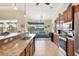 Open kitchen with granite island, stainless steel appliances and breakfast bar at 15608 Lakeland Cir, Port Charlotte, FL 33981