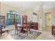 Elegant dining room with a large table, chandelier, and hardwood floors at 15608 Lakeland Cir, Port Charlotte, FL 33981