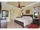 Large bedroom with ensuite bath access, featuring a king-size bed and a calm color scheme at 15608 Lakeland Cir, Port Charlotte, FL 33981