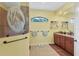 Elegant bathroom with double vanity and a large walk-in shower with glass enclosure at 15608 Lakeland Cir, Port Charlotte, FL 33981