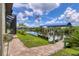 Private dock with covered boat lift and lush landscaping at 15608 Lakeland Cir, Port Charlotte, FL 33981