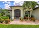 House exterior showcasing a lush garden and front entrance at 15608 Lakeland Cir, Port Charlotte, FL 33981