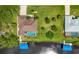 Bird's-eye view of house, pool, and private dock on the canal at 15608 Lakeland Cir, Port Charlotte, FL 33981