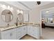 Double vanity bathroom with granite countertop and view of bedroom at 11000 Placida Rd # 2303, Placida, FL 33946