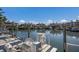 Boats docked at a marina with waterfront homes in the background at 11000 Placida Rd # 2303, Placida, FL 33946