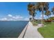 Scenic waterfront pathway with palm trees and grassy areas at 11000 Placida Rd # 2303, Placida, FL 33946