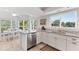 Modern kitchen with island, white cabinets, granite countertops, and stainless steel appliances at 11000 Placida Rd # 2303, Placida, FL 33946
