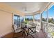 Private screened balcony with table and chairs, perfect for outdoor dining at 11000 Placida Rd # 2303, Placida, FL 33946