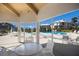 Screened-in patio with table and chairs overlooking the pool at 11000 Placida Rd # 2303, Placida, FL 33946