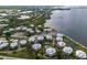 Aerial view of waterfront community, showing numerous buildings and landscaping at 11000 Placida Rd # 2303, Placida, FL 33946