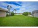 Landscaped backyard with lake view at 1101 Covey Cir, Venice, FL 34293