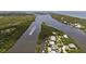 Aerial view of waterfront property with boat and lush landscaping at 11160 Hacienda Del Mar Blvd # D-205, Placida, FL 33946