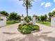 Community entrance with landscaping and signage at 11160 Hacienda Del Mar Blvd # D-205, Placida, FL 33946