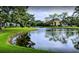 Peaceful lake with reflection of condominium buildings at 8 Quails Run Blvd # 10, Englewood, FL 34223