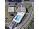 Community pool with surrounding lounge chairs and shuffleboard at 8 Quails Run Blvd # 10, Englewood, FL 34223